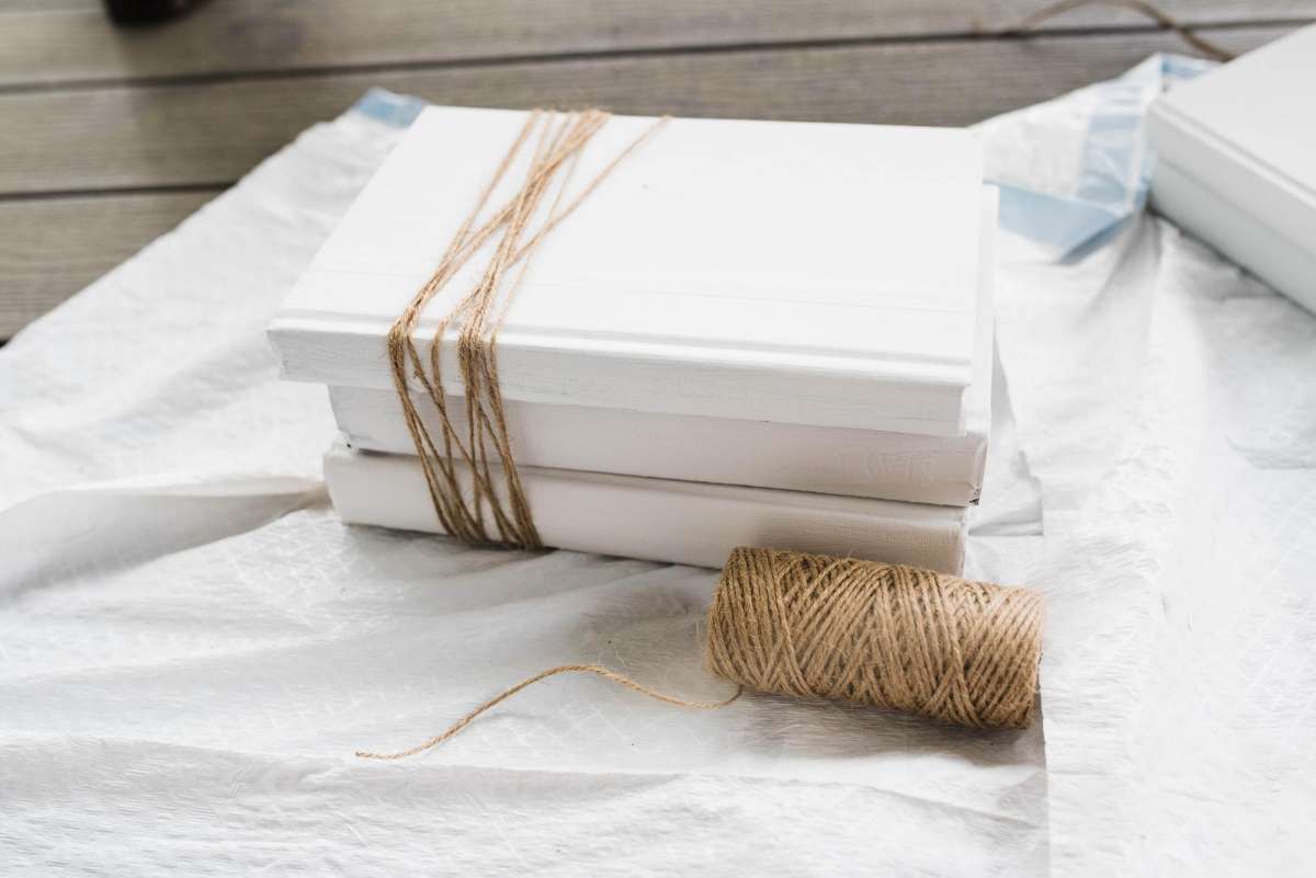 white books bundled with twine