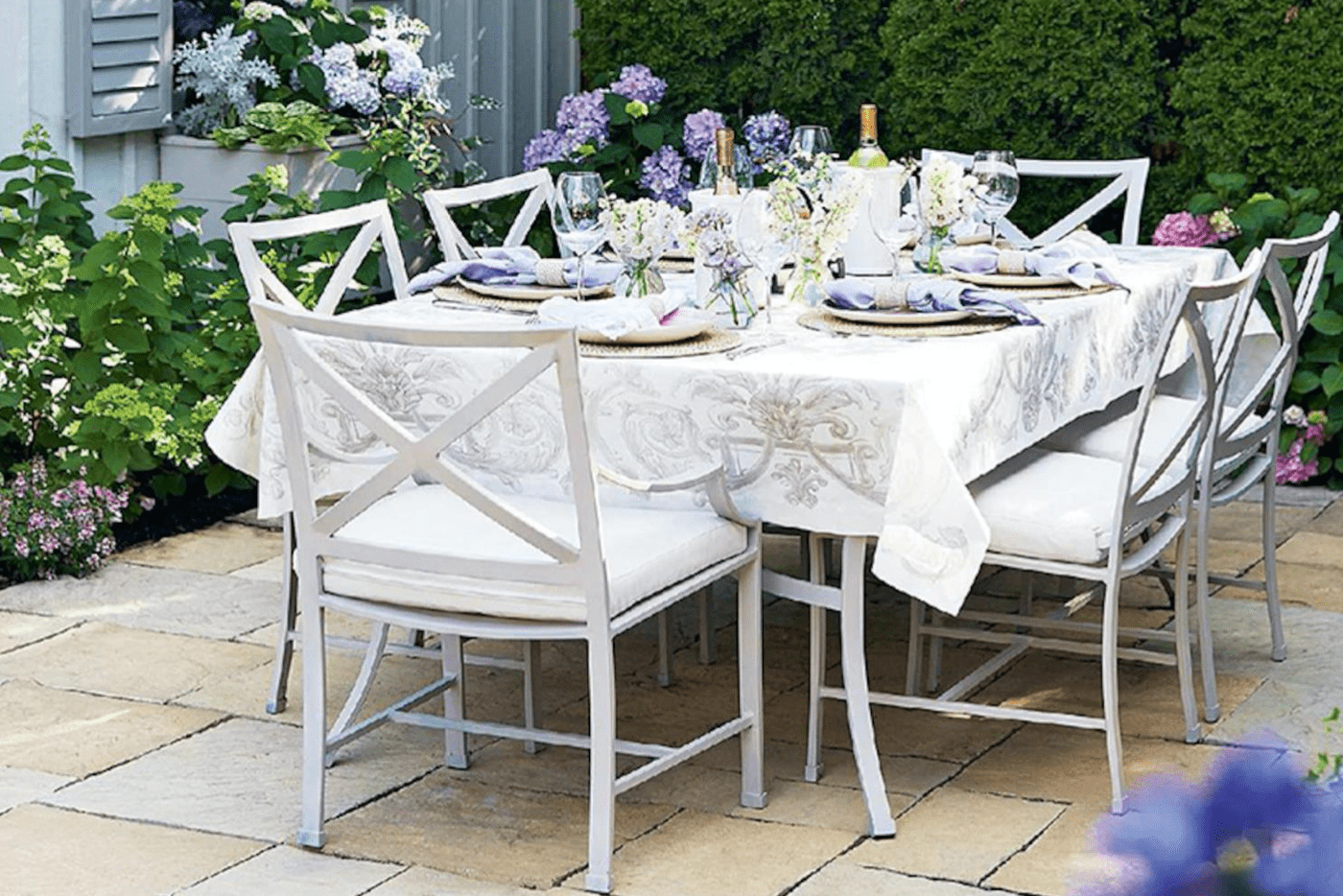 white table with white chair and floral place setting