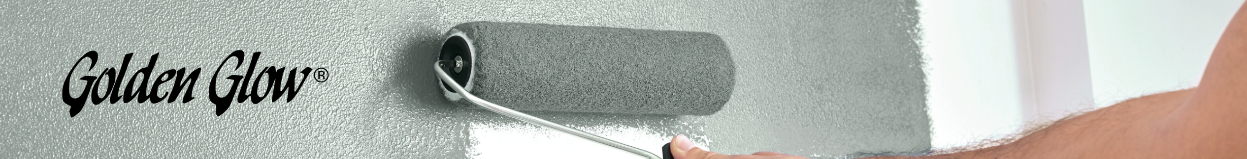 Someone using a paint roller to paint a wall green.