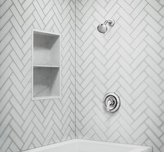 Shower with white tiling and a stainless steel showerhead.