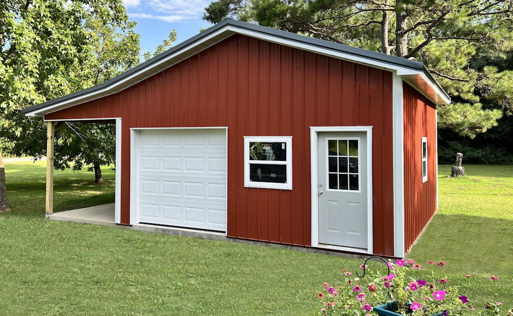 A red garage with one overhead door and one entry door.