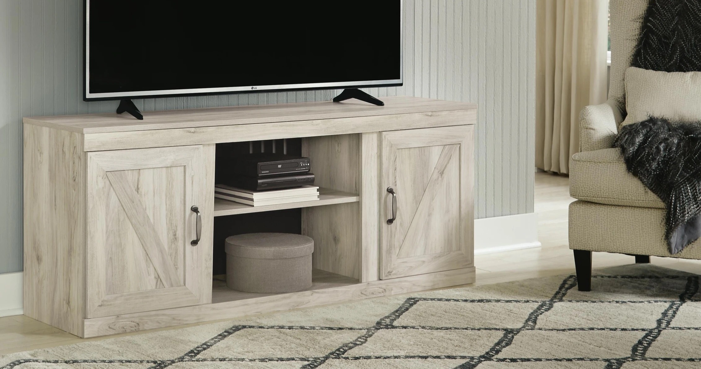 Light wood TV stands with two side doors.
