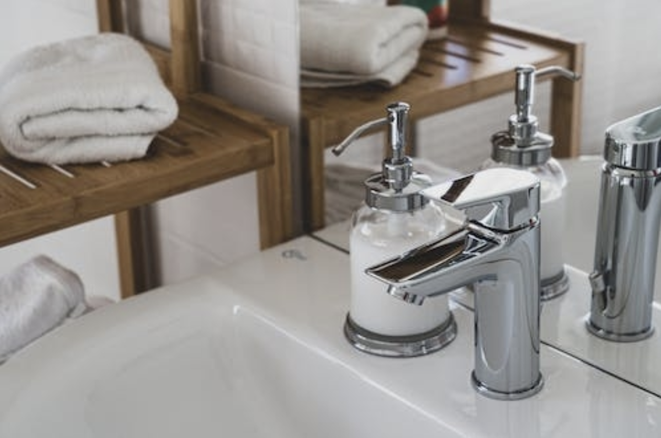 A white bathroom sink with silver plumbing fixtures.