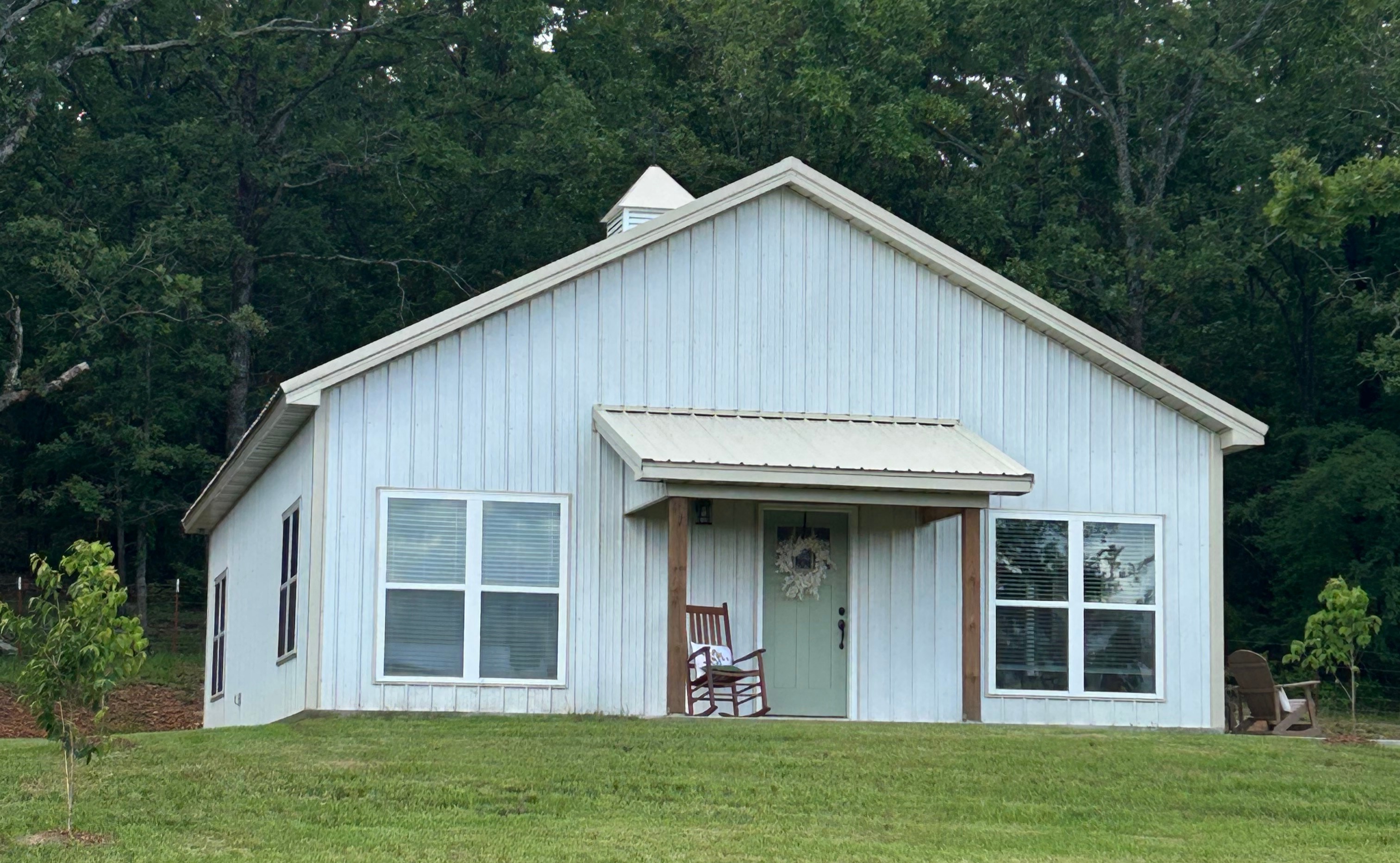 White barndominium with black trim.