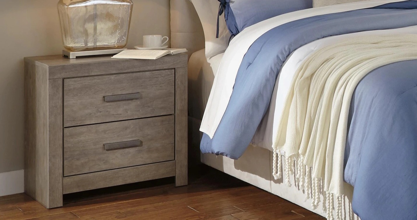 Light brown nightstand with two drawers.