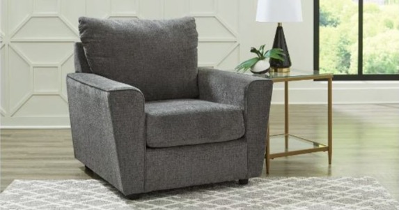 Medium gray chair next to a old accent side table. 